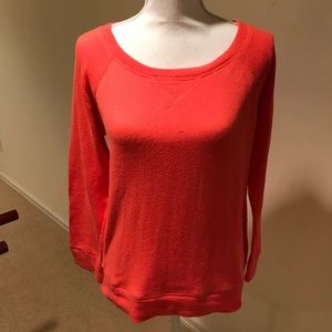 A J.Crew orange sweatshirt.